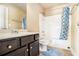 Bathroom showing a vanity sink and shower with patterned curtain at 3621 Guinevere Trce, Douglasville, GA 30135