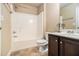 Bright bathroom featuring a shower-tub combo, dark cabinets, and neutral tiling at 3621 Guinevere Trce, Douglasville, GA 30135