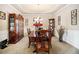 Elegant dining room with a large table, china cabinet, and decorative wall art at 3621 Guinevere Trce, Douglasville, GA 30135