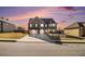 Charming two-story brick home features a two-car garage, landscaped yard, and sunset sky at 3621 Guinevere Trce, Douglasville, GA 30135