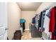 A well-lit laundry room with appliances and clothing racks for easy organization at 3621 Guinevere Trce, Douglasville, GA 30135