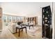 Open-concept living area with neutral walls, multiple windows, carpeted flooring, and modern lighting at 3621 Guinevere Trce, Douglasville, GA 30135