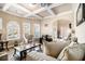 Inviting living room featuring coffered ceilings, arched windows, and ample natural light at 3621 Guinevere Trce, Douglasville, GA 30135