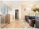 This main bathroom features a glass enclosed shower, tile floors, and and dark wood vanities at 3621 Guinevere Trce, Douglasville, GA 30135