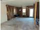 Living room under renovation, featuring exposed framing, a window, and an exterior door at 4195 Turner Dr, Cumming, GA 30040