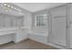 Bright bathroom features a soaking tub, glass-enclosed shower, and vanity with plenty of counter space at 5755 Vinings Place Se Ct, Mableton, GA 30126