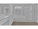 Bright bathroom features a soaking tub, glass-enclosed shower, and vanity with plenty of counter space at 5755 Vinings Place Se Ct, Mableton, GA 30126