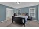 Bedroom with blue walls, carpeted floors, and an ensuite bathroom for added convenience at 5755 Vinings Place Se Ct, Mableton, GA 30126