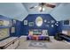 Unique attic bedroom with blue walls, carpeted floors, and creative decor at 5755 Vinings Place Se Ct, Mableton, GA 30126