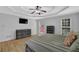 Spacious primary bedroom featuring a tray ceiling, hardwood floors, and a large dresser at 5755 Vinings Place Se Ct, Mableton, GA 30126