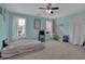 Bright bedroom with blue accents, carpeted floors, and two windows for ample natural light at 5755 Vinings Place Se Ct, Mableton, GA 30126