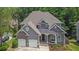 Attractive exterior featuring stone accents, a covered porch, and a spacious two-car garage at 5755 Vinings Place Se Ct, Mableton, GA 30126