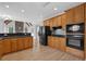Spacious kitchen features wood cabinets, dark countertops, stainless steel appliances, and wood floors at 5755 Vinings Place Se Ct, Mableton, GA 30126