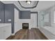Main bathroom with gray walls, dual sink vanity, fireplace, glass shower, and soaking tub at 5755 Vinings Place Se Ct, Mableton, GA 30126