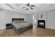 Bright bedroom with tray ceiling, hardwood floors, a large window and a stylish furniture set at 5755 Vinings Place Se Ct, Mableton, GA 30126
