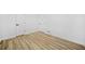 Spacious bedroom with two doors and wood-look flooring at 897 Marie Sw Ln, Conyers, GA 30094