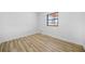 Bright bedroom with wood-look flooring and a window at 897 Marie Sw Ln, Conyers, GA 30094