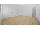Bright bedroom with light wood floors, white walls, and access to a sleek, modern bathroom at 897 Marie Sw Ln, Conyers, GA 30094