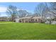 Beautiful home with lush green lawn, brick facade, and white trim under a blue sky at 897 Marie Sw Ln, Conyers, GA 30094