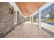 Covered patio featuring stained wood ceiling, ceiling fan, and tile floors that lead to the pool at 897 Marie Sw Ln, Conyers, GA 30094