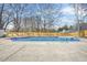 A fenced-in backyard featuring a swimming pool, concrete patio, and minimal landscaping at 897 Marie Sw Ln, Conyers, GA 30094