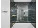 Black marble shower with gold fixtures, including rain head and handheld wand at 897 Marie Sw Ln, Conyers, GA 30094