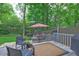 Cozy backyard deck with patio furniture, an outdoor rug, and shade, perfect for relaxation at 1160 Haven Brook Ne Way, Brookhaven, GA 30319