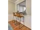 Charming breakfast bar featuring two leather stools, hardwood floors, and views of the kitchen at 1160 Haven Brook Ne Way, Brookhaven, GA 30319