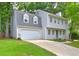 Charming two-story home featuring a two-car garage, gray siding, and meticulously maintained front lawn at 1160 Haven Brook Ne Way, Brookhaven, GA 30319