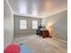 Bright, carpeted office area featuring a large desk, lamps, plants, and exercise equipment at 1160 Haven Brook Ne Way, Brookhaven, GA 30319