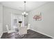 Elegant dining room with modern chandelier, seating for four, and hardwood floors at 20 Pine Canyon Sw Dr # 26, Atlanta, GA 30331
