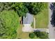 Aerial view of a home with a driveway and grassy lawn surrounded by trees at 213 Johnstons Dr, Dallas, GA 30157