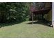 Exterior of a home featuring a green lawn and backyard at 213 Johnstons Dr, Dallas, GA 30157