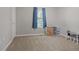 Bedroom with neutral walls and blue curtains over the windows at 213 Johnstons Dr, Dallas, GA 30157