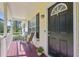 Inviting front porch with seating, a black front door, and a view of the surrounding greenery at 213 Johnstons Dr, Dallas, GA 30157