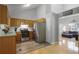 Bright eat-in kitchen with stainless appliances, wood cabinets, and a view into the adjacent living room at 213 Johnstons Dr, Dallas, GA 30157