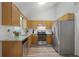 Modern kitchen with stainless steel appliances, light wood cabinets, and a bright window above the sink at 213 Johnstons Dr, Dallas, GA 30157