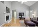 Cozy living room with fireplace and high ceilings. Hardwood floors and ample natural light add to the comfortable ambiance at 213 Johnstons Dr, Dallas, GA 30157