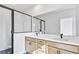 Modern bathroom featuring double vanity sinks, quartz countertops, and an enclosed shower with sleek black frame at 2592 Alcovy Ne Trl, Marietta, GA 30066