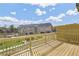 Townhome deck boasting wood railings and flooring, overlooking the community's green space and picturesque blue sky at 2592 Alcovy Ne Trl, Marietta, GA 30066