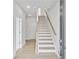 Bright entryway featuring white-painted walls, hardwood floors, and a staircase with natural wood handrail at 2592 Alcovy Ne Trl, Marietta, GA 30066