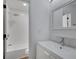 Bright bathroom featuring a modern vanity, white fixtures, and shower with tile surround at 293 Quail Run, Roswell, GA 30076