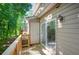 A spacious deck with wooden railings provides a serene outdoor space surrounded by lush greenery and natural light at 293 Quail Run, Roswell, GA 30076