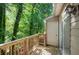 A spacious deck with wooden railings provides a serene outdoor space surrounded by lush greenery and natural light at 293 Quail Run, Roswell, GA 30076