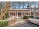Charming multi-Gathering home featuring a welcoming entrance, brick accents, and mature landscaping in a quiet residential area at 293 Quail Run, Roswell, GA 30076
