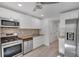 Bright kitchen features stainless steel appliances, butcher block counters, and neutral tile backsplash at 293 Quail Run, Roswell, GA 30076