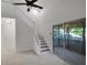 Airy living space features stairs to the second floor, providing easy access to the home's upper level at 293 Quail Run, Roswell, GA 30076
