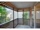 Relaxing screened-in patio with lattice details and a view of lush greenery at 293 Quail Run, Roswell, GA 30076