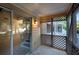 Covered patio featuring a sliding glass door, American Flag, and lattice details at 293 Quail Run, Roswell, GA 30076