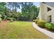 Lush backyard featuring a well-maintained lawn, mature trees, and a playset at 1018 Layfield Ct, Dunwoody, GA 30338